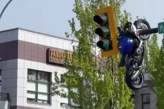 Moto termina colgada de semáforo tras chocar contra auto (+Video)